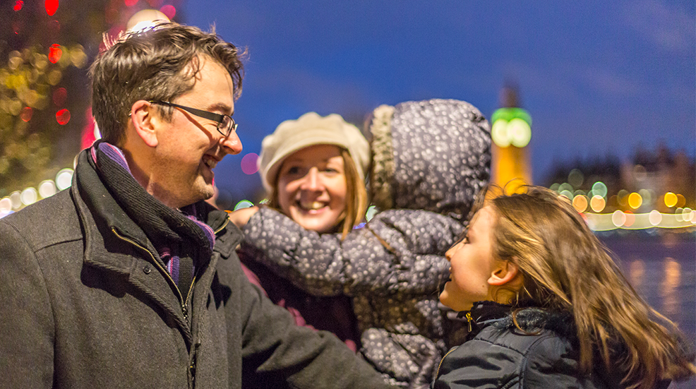 Happy family hugging while sightseeing on Christmas vacation in London England